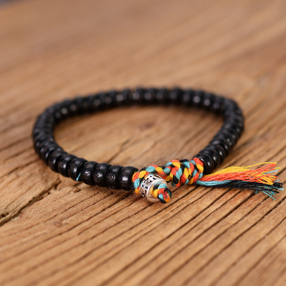 Bracelet Tibétain Bouddhiste en perle de Noix de Coco taillées et gravées.