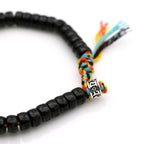 Bracelet Tibétain Bouddhiste en perle de Noix de Coco taillées et gravées.